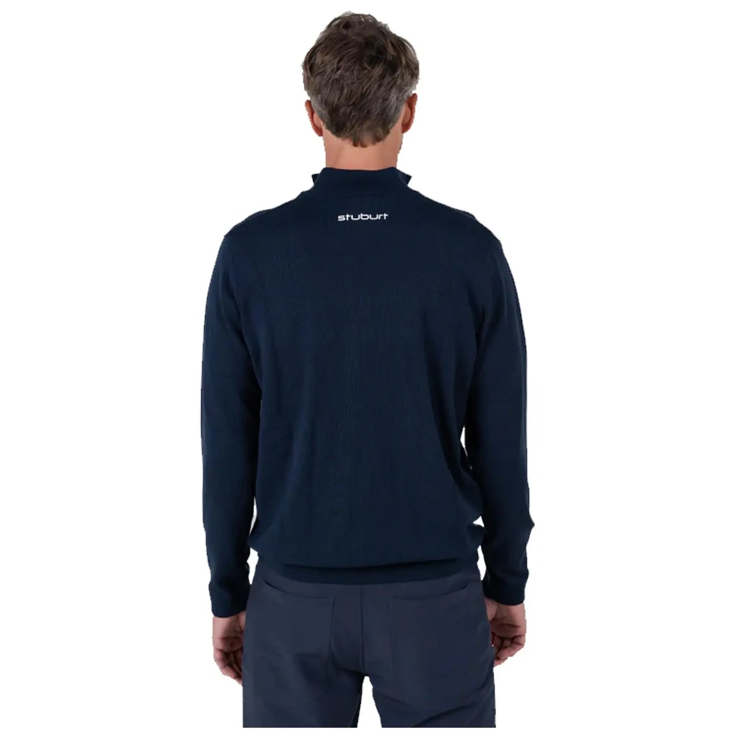 A man is wearing a dark navy sweater with a high collar and is shown from the back against a plain white background, highlighting the sweater's texture and branding.