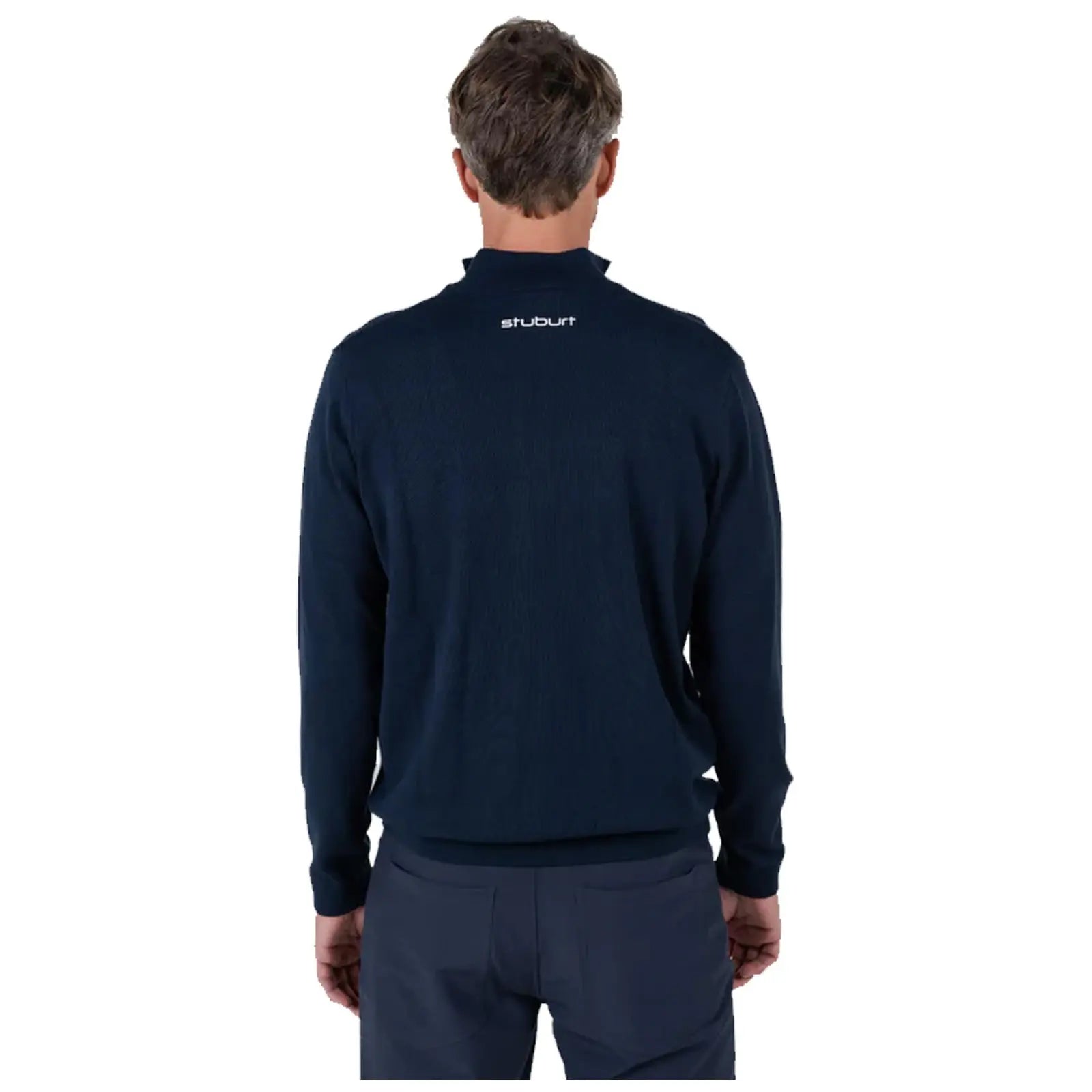 A man is wearing a dark navy sweater with a high collar and is shown from the back against a plain white background, highlighting the sweater's texture and branding.