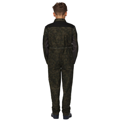 A child is standing with their back to the viewer wearing a dark green camouflage jumpsuit with black paneling on the shoulders and arms in a plain white background.