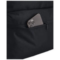 A black fabric bag contains a partially visible smartphone nestled in a zippered pocket showcasing its sleek design and camera layout in a casual storage setting.