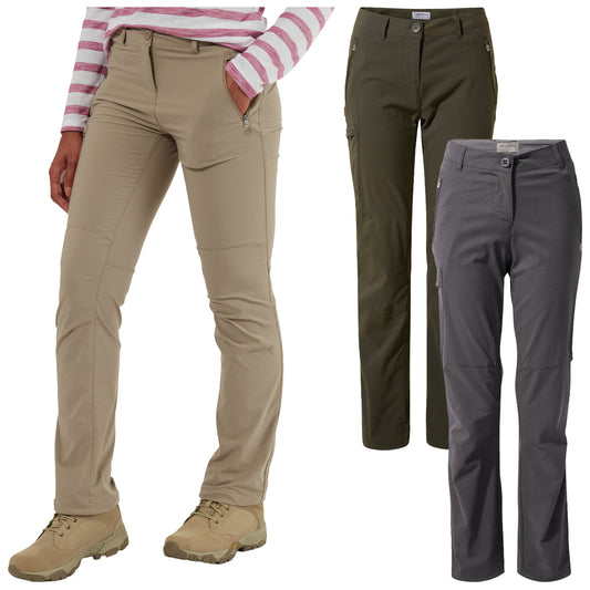 Three pairs of outdoor pants in khaki olive and gray are displayed with one pair worn by a person who has their hand in a pocket standing in a casual pose