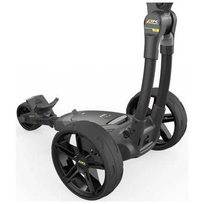 A golf push cart with sleek black wheels and a sturdy frame is positioned upright showcasing its features including handles and a control panel in a minimalistic white background.
