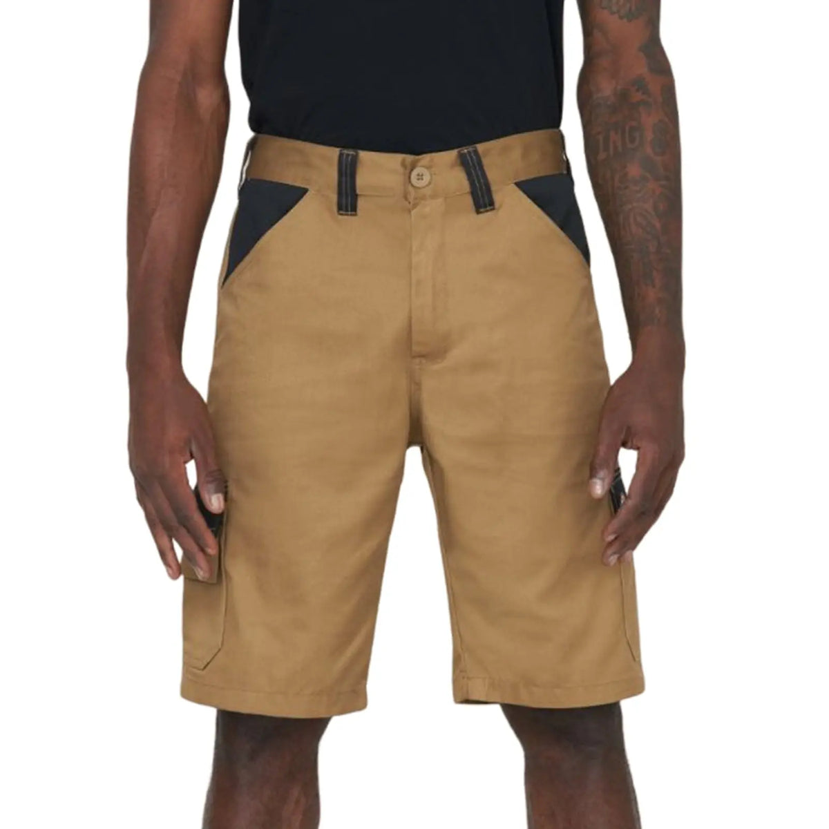 Tan shorts are worn by a person standing upright with hands at their sides The shorts feature black accents near the pockets and are part of a casual outfit in a neutral setting