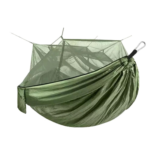 A green hammock is suspended and designed for relaxation featuring a netting cover for insect protection creating a comfortable resting space in an outdoor environment.