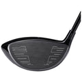 A black titanium golf club head is shown angled slightly, showcasing its smooth surface and engraved markings for alignment and performance, designed for use in golfing contexts.