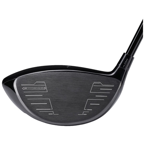 A black titanium golf club head is shown angled slightly, showcasing its smooth surface and engraved markings for alignment and performance, designed for use in golfing contexts.