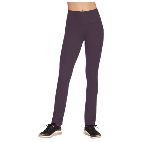 Leggings in a dark purple color are displayed standing upright with a high waistband and two side pockets paired with black athletic shoes on a neutral background.