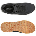 A black athletic shoe is displayed with a breathable upper and gray laces resting on a white background featuring a textured rubber outsole designed for grip and support. The insole has "SKECHERS Air-Cooled MEMORY FOAM" printed inside.