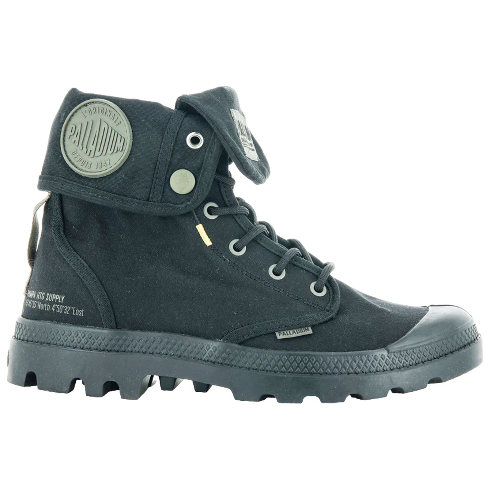A black canvas boot stands upright featuring a high-top design with a folded tongue secured by a snap button showcasing a rugged sole and various branding details.