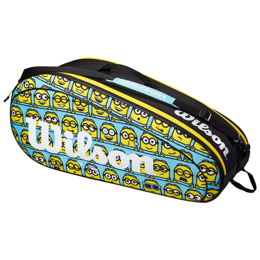 A colorful tennis bag features a pattern of various cartoon yellow characters with big eyes and different expressions The bag is black and blue with the Wilson logo prominently displayed