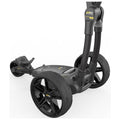 A black and gray golf push cart stands on a white background featuring three large wheels a handle with electronic controls and a storage compartment highlighting its compact design and functionality.