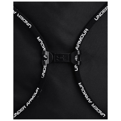 A black backpack features a clasp with adjustable straps displaying "UNDER ARMOUR" text the bag is positioned flat showing its design and closure mechanism.