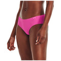 A bright pink bikini bottom is worn by a person standing upright with their hand resting on their thigh in a neutral background highlighting the garment's vibrant color and sleek design.