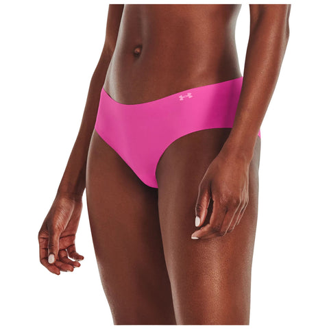 A bright pink bikini bottom is worn by a person standing upright with their hand resting on their thigh in a neutral background highlighting the garment's vibrant color and sleek design.