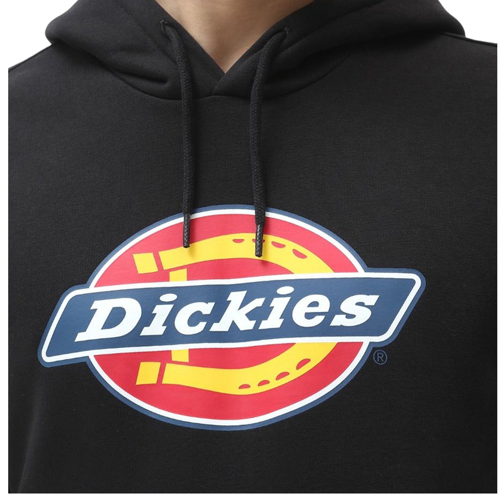 A black hoodie features a vibrant circular logo with red and yellow elements displaying the word Dickies prominently across the center against a plain background.