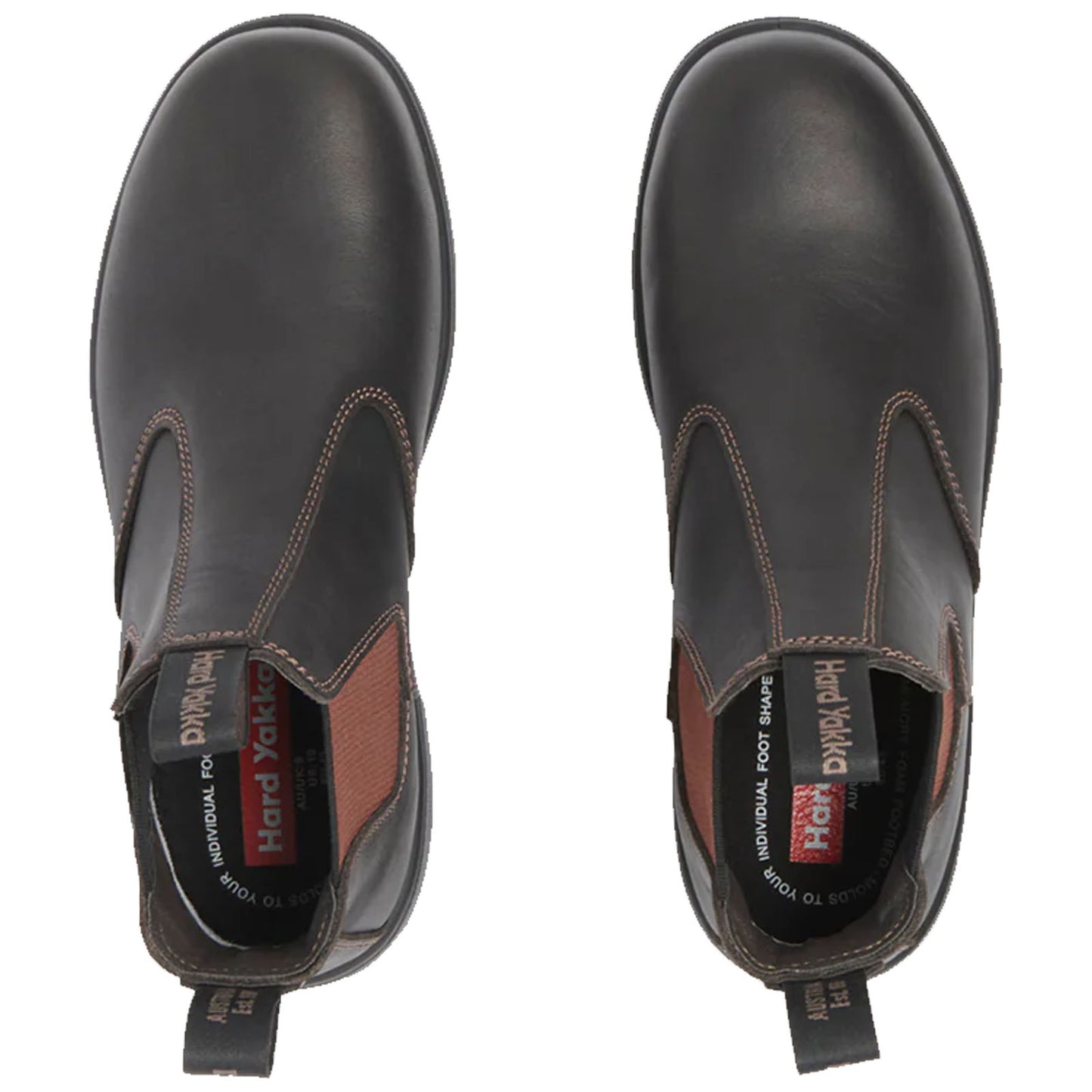 Black leather ankle boots are positioned upright showcasing rounded toes and elastic side panels designed for easy wear with a textile lining and branding visible inside and on the pull tab