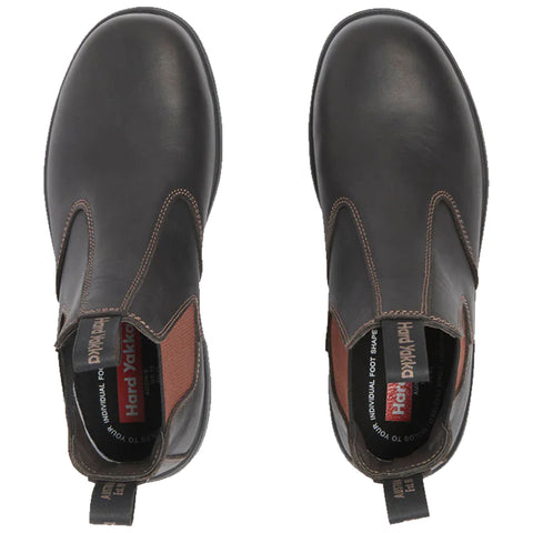 Black leather ankle boots are positioned upright showcasing rounded toes and elastic side panels designed for easy wear with a textile lining and branding visible inside and on the pull tab