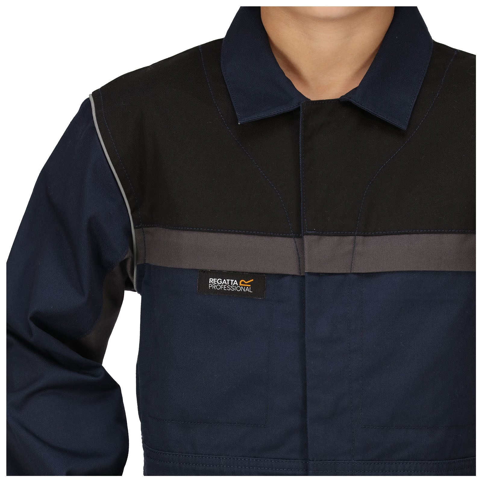 A navy blue work jacket with darker shoulder panels is worn by a person standing. The jacket features a Regatta Professional logo on the front and has a collar.