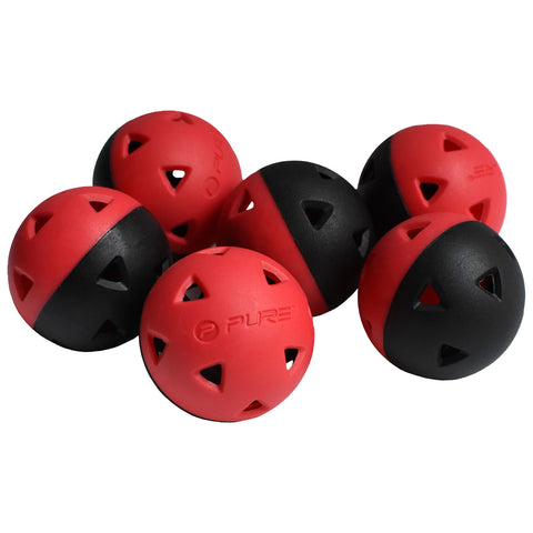 A group of six dual-colored balls is arranged closely together with red and black halves and triangular cutouts showcasing a playful design suitable for various activities like fetch or exercise.