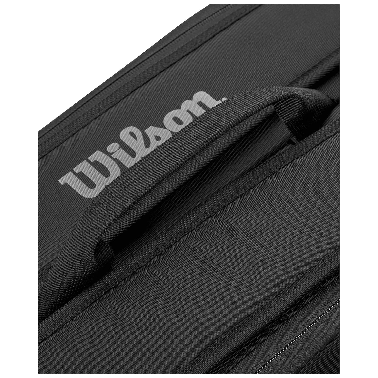 A black sports bag with a prominent white "Wilson" logo on the side is positioned at an angle revealing its handle and zipper area.