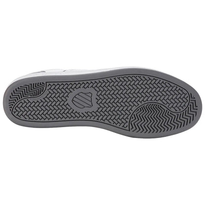 A shoe's sole is displayed with a textured design underneath showcasing grooves and patterns for traction emphasizing its functional purpose on different surfaces.