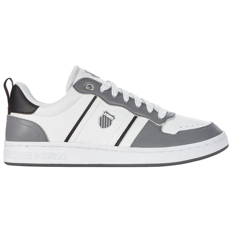 A gray and white sneaker is positioned on a flat surface with a sleek design featuring a logo on the side and laces threaded through eyelets creating a casual sports aesthetic.