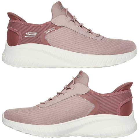 A pair of pink athletic shoes rests on a neutral background showcasing a textured upper and a thick white sole designed for comfort and support in casual or active settings.