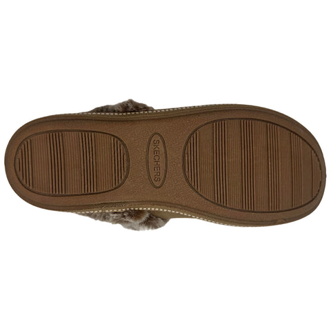 A brown shoe sole with a textured pattern lays flat showcasing the Skechers logo and rubber tread designed for grip in a neutral environment.