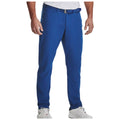 Blue pants are being worn by a person standing with a casual pose while dressed in a short-sleeved patterned shirt and white athletic shoes in a plain background.