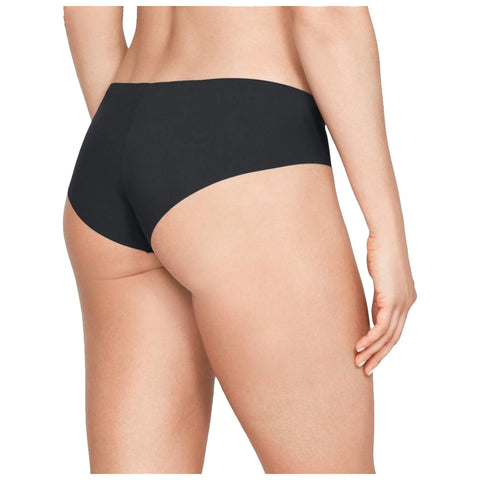 Black underwear is showcased on a female figure from behind with a natural pose emphasizing the garment’s fit and style against a plain light background.