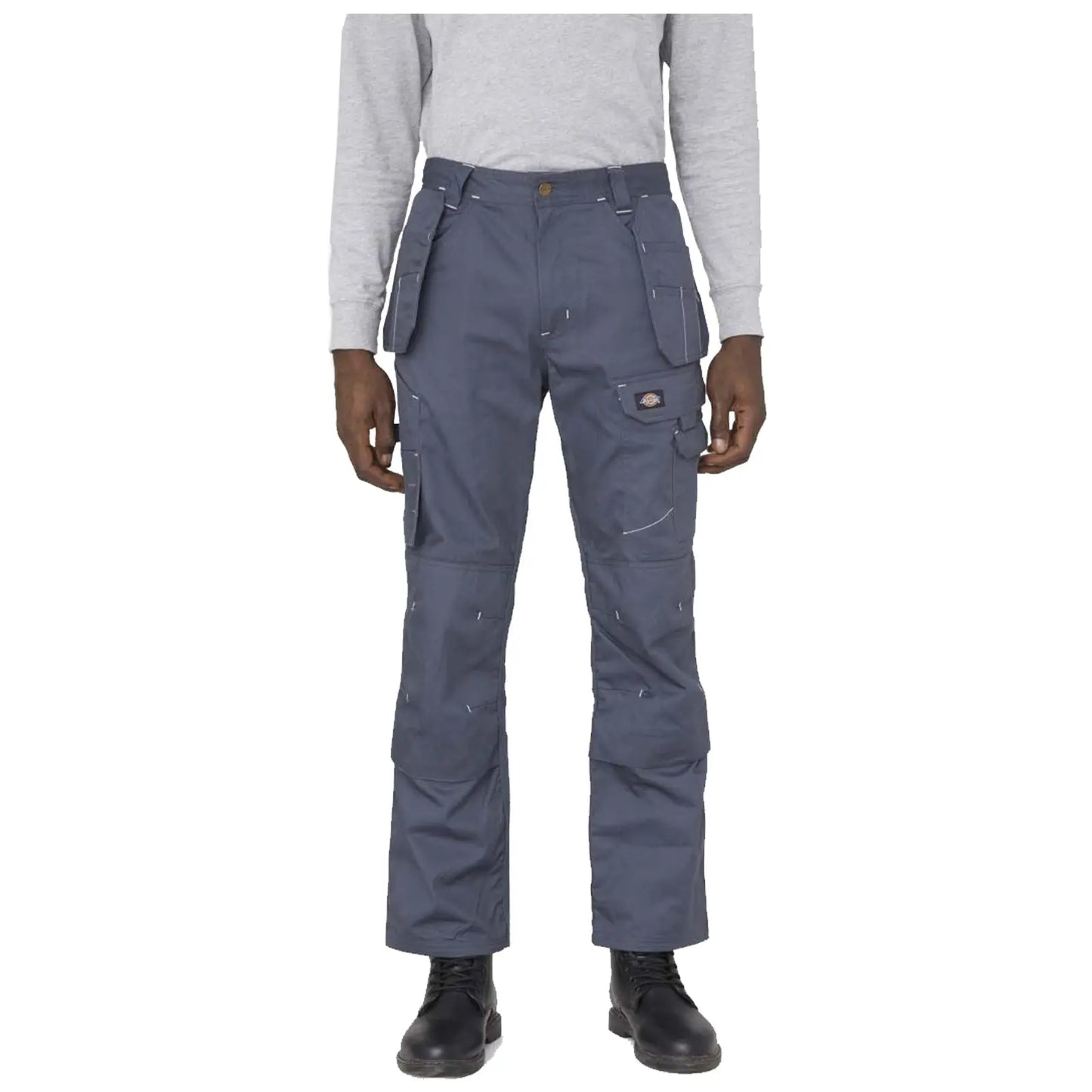 Dark gray cargo pants are being worn by a person with black boots standing in front of a neutral background. The pants feature multiple pockets and visible stitching details.