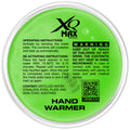 A round green hand warmer contains instructions on activation and reactivation by bending a metal plate and using hot water with a warning about safety precautions and contents.
