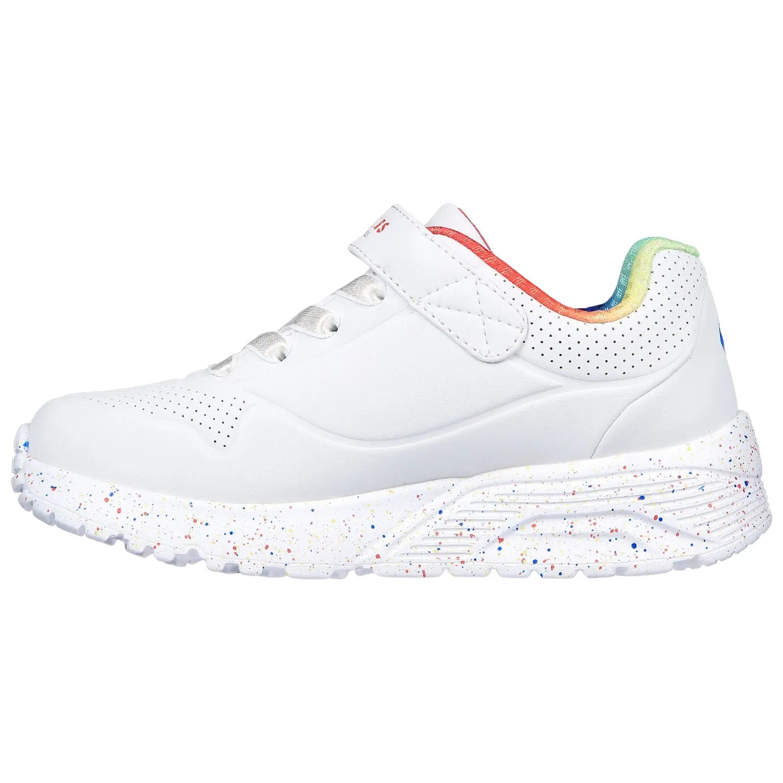 A white athletic shoe features a velcro strap and colorful accents on the heel with a speckled sole indicating a playful design suitable for casual or active wear.