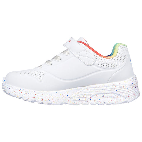 A white athletic shoe features a velcro strap and colorful accents on the heel with a speckled sole indicating a playful design suitable for casual or active wear.