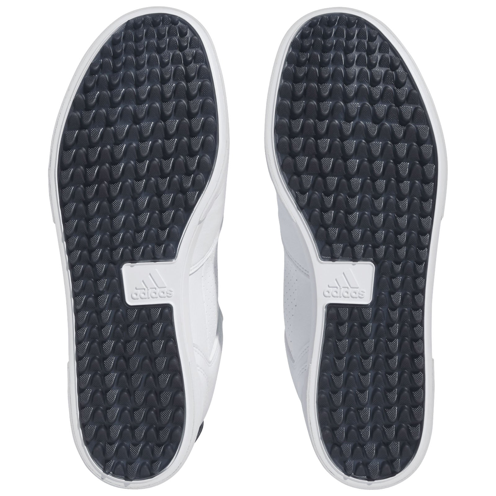 Two shoe soles are displayed with a white and black color scheme featuring a textured surface for grip. The surrounding environment is neutral and lacks any distinct elements.