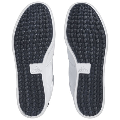 Two shoe soles are displayed with a white and black color scheme featuring a textured surface for grip. The surrounding environment is neutral and lacks any distinct elements.