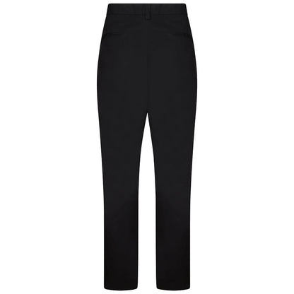 Black trousers are displayed upright showcasing a straight-leg design and no visible embellishments in a plain, uncluttered setting emphasizing their simple and classic style