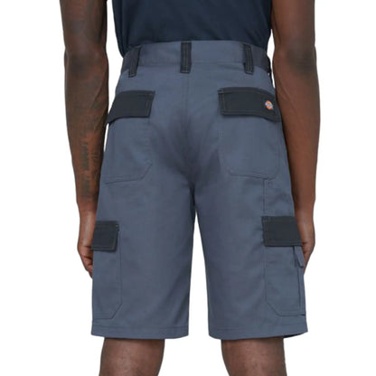 Gray cargo shorts are worn by an individual facing away from the viewer with visible pockets on the sides the setting appears to be casual or outdoor.