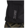 Black waterproof jacket with “AQUADRY Waterproof Systems” text is shown alongside a rugged boot featuring dark green and black elements in an outdoor or adventurous context.