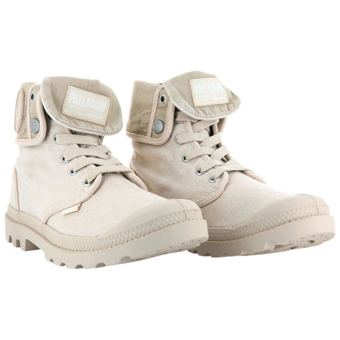 A pair of beige high-top boots with laces and a foldable collar rests side by side on a white background showcasing their textured canvas material and rugged rubber soles.