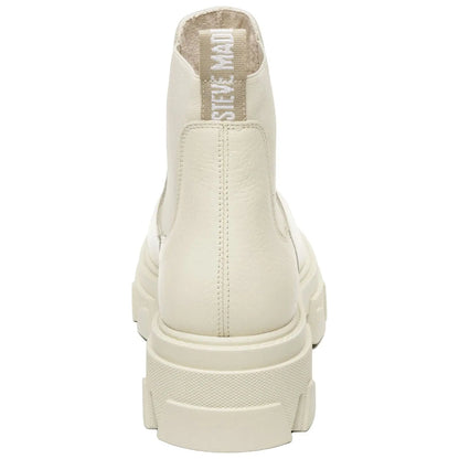 A pair of creamy white chunky ankle boots stands upright showcasing their textured surface and thick sole with a looped tag on the back suggesting a stylish and modern design.