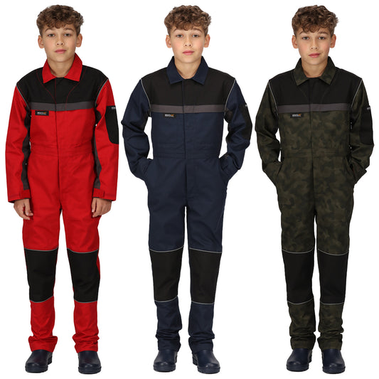 Three children are standing side by side wearing different colored coveralls. The first is red the second is navy blue and the third is camouflage. They all have hands in pockets.