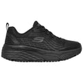 A black athletic shoe with a textured mesh upper and thick sole rests on a flat surface showcasing its sleek silhouette designed for comfort and support during physical activities.