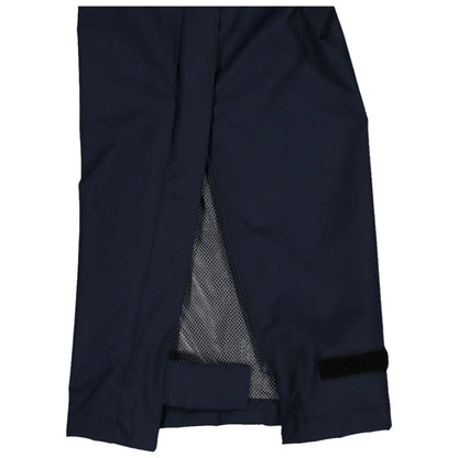 A pair of dark fabric pants is displayed partially open showing a mesh lining inside the unzipped section near the ankle with a hook and loop adjustment strap at the bottom.