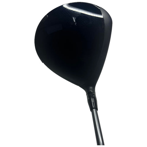 A black golf driver is positioned upright against a plain background showcasing its glossy head and sleek shaft ready for use on a golf course or range.