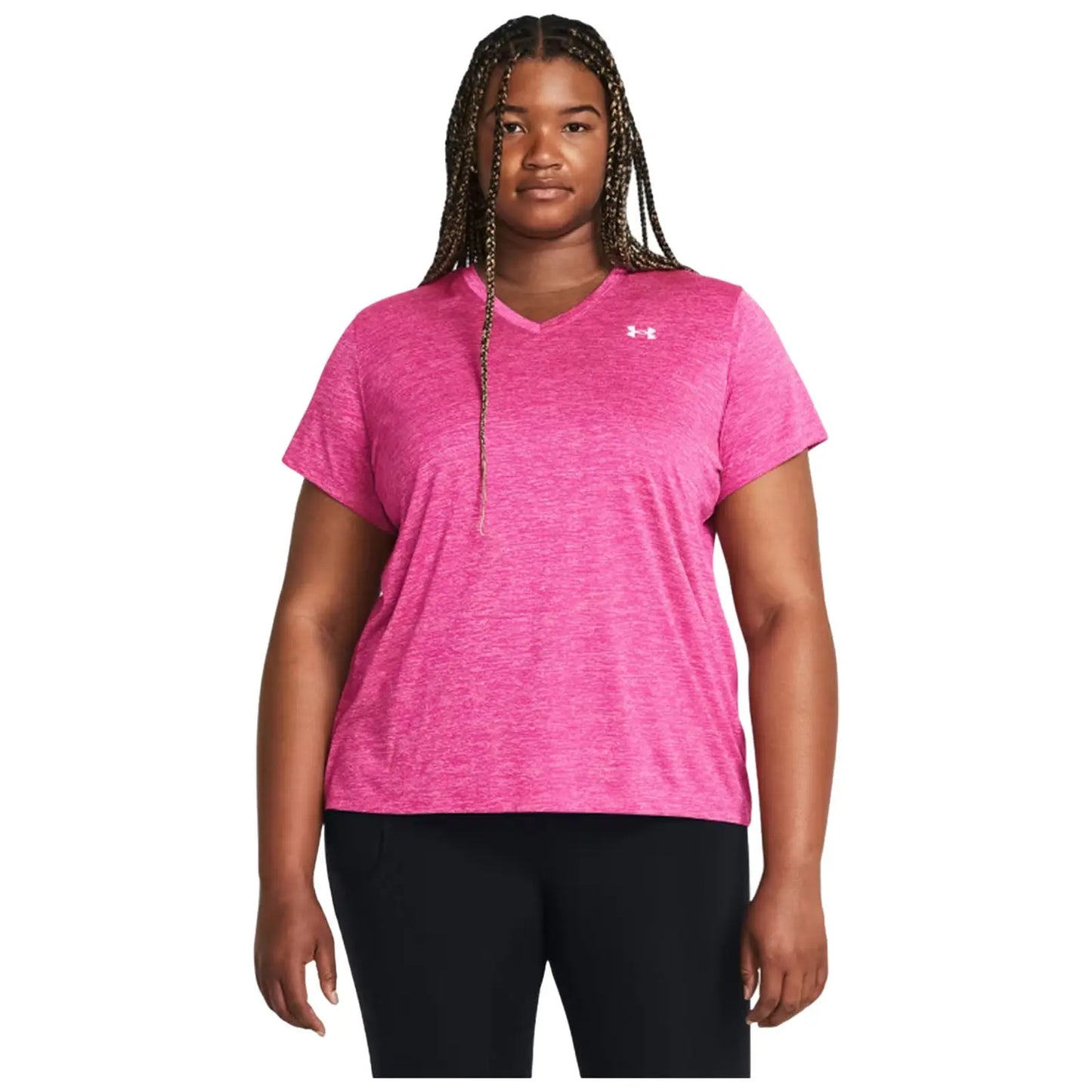 A person stands facing forward wearing a pink athletic t-shirt with short sleeves and a v-neck alongside black pants in a neutral background environment.