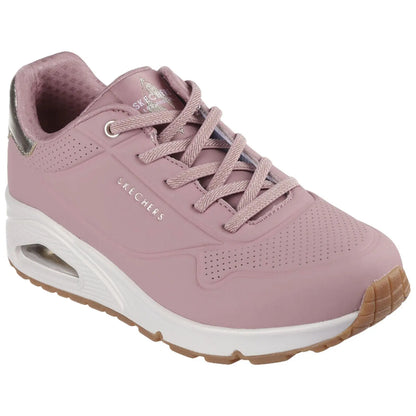 A pink sneaker with a textured design features laces and a cushioned sole. It is set against a neutral background, showcasing its sporty style and comfort-focused design.