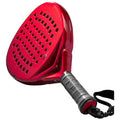 A vibrant red pickleball paddle features a large perforated hitting surface and a black textured grip with a safety strap, designed for gameplay in indoor or outdoor settings.