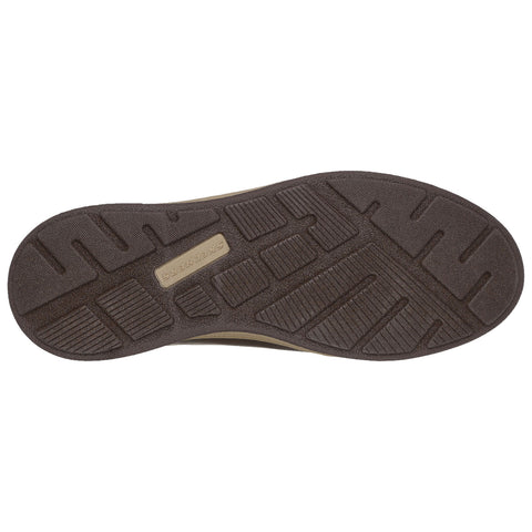 A shoe sole is displayed upright showcasing a textured rubber surface with various patterns for grip and traction in an undefined environment emphasizing its design and purpose.