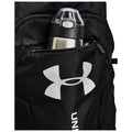 A black backpack features a water bottle in an external zippered pocket. The water bottle has a silver insulated body and a clear lid with a push button. The backpack displays a large white logo.